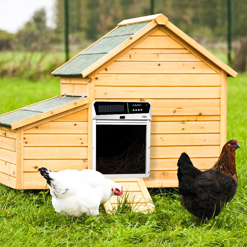 Wooden chicken coop with a solar panel on a grassy field