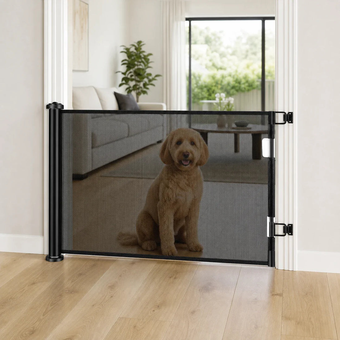 Black retractable mesh dog gate installed in a modern doorway