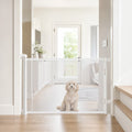 White retractable mesh pet gate installed in a bright doorway with dog