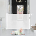 Retractable pet gate for dogs installed in doorway – black mesh design